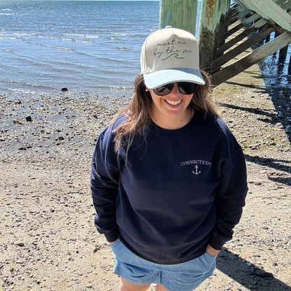 Meet me by the sea trucker cap modeled on a beach in Connecticut