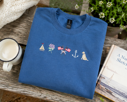 blue sweatshirt with embroidered designs on a white background.